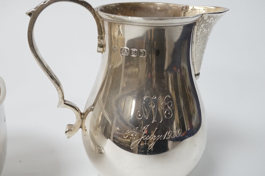 A George VI silver cream jug and sugar bowl by Blackmore & Fletcher Ltd, London, 1939, jug 10.9cm, 11.9oz, with engraved inscription. Condition - fair to good